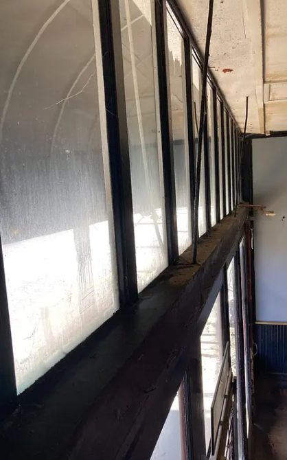 Windows with hard-water grime and stains before treatment